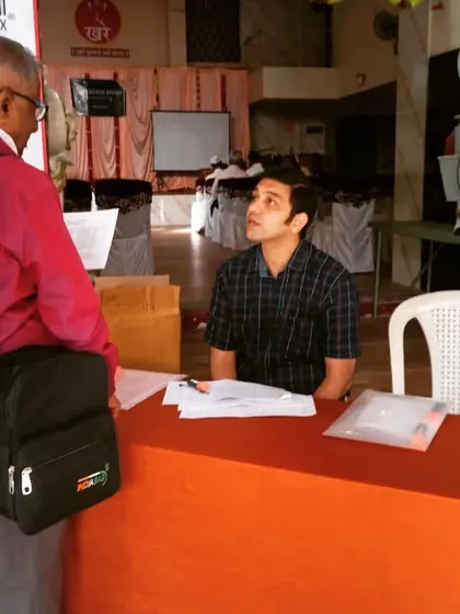 Personal interaction is at the heart of what I do. Here, a parent is speaking with a member of my team at the registration desk, getting clarifications and ensuring they understand how the event will unfold.
