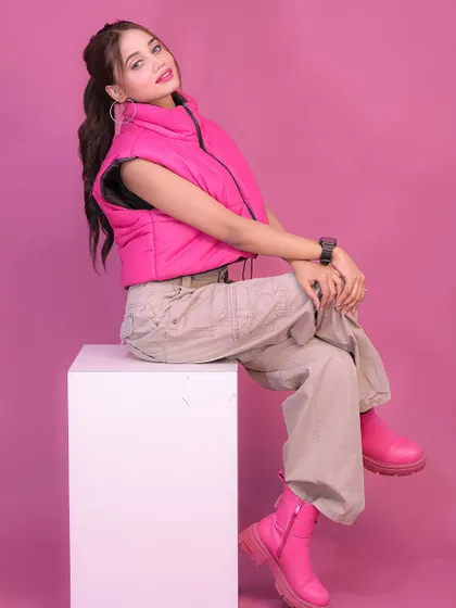 A confident, seated pose that showcases the full outfit in a fun and engaging way.