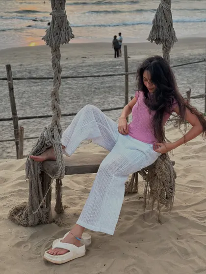 Adjusting my outfit on the beach swing. Even the in-between moments are part of the fun and relaxed vibe of the trip.
