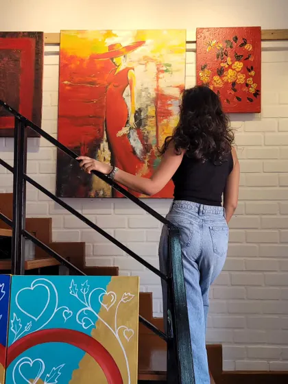 A visitor on the stairs of our gallery during the "LOVE UNFILTERED" Valentine's exhibition. Our multi-level space offers different perspectives and art discoveries.