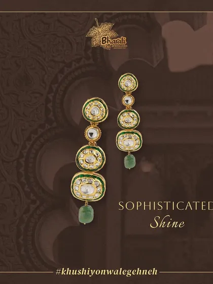 Make a statement with these exquisite long earrings. Handcrafted with four tiers of Kundan and Meenakari work, and adorned with shimmering pearls and a final green bead drop, they offer a sophisticated shine.