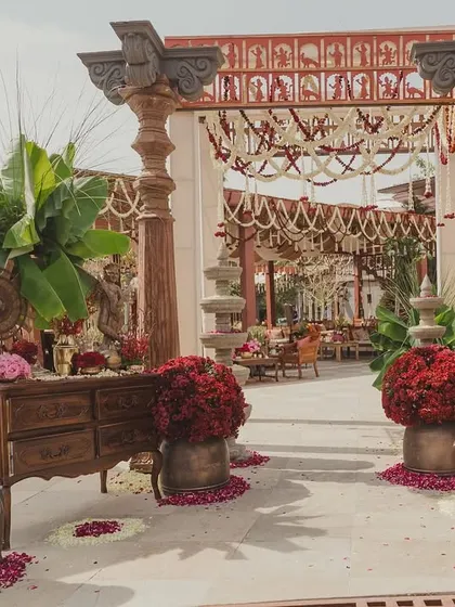 The grand entrance to the Mehendi, featuring carved pillars, large banana plants, and elephant sculptures.