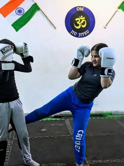 A strong foundation is everything. This young student demonstrates a perfect kick during a Muay Thai drill, showcasing the excellent technique and power we build in our kids' classes.