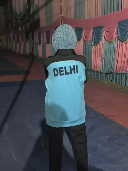 Representing Delhi. Ayush Kumar proudly wearing his team jacket before competing at the Sub-Junior National Championship.