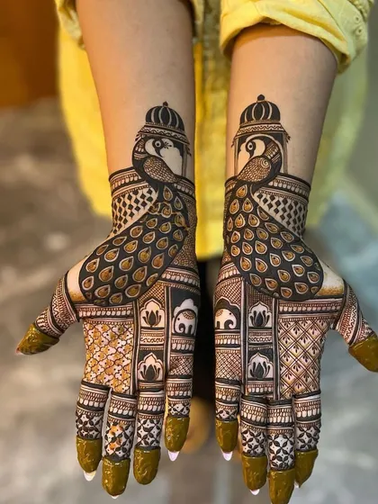 A majestic peacock design for a bride. The peacocks are the centerpiece, with their feathers beautifully detailed. The palms are filled with traditional motifs like elephants and lotuses.