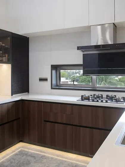 Another perspective of the walnut kitchen, showing the sleek chimney and the window that floods the workspace with natural light. It’s a kitchen designed for the way you actually live.