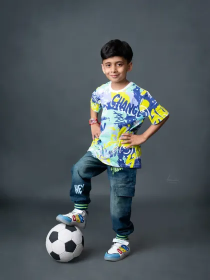 A confident pose from this 7-year-old, showing that photoshoots can be fun and cool at any age.