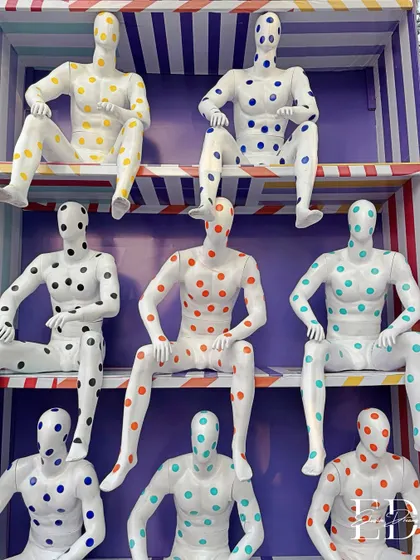 A wider view of the multi-tiered mannequin installation, showcasing its scale and impact within the venue.