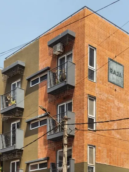 The facade of the Pixel 2 apartment building is a nod to Bengaluru's identity. We used locally sourced red bricks reminiscent of colonial architecture and a textured green plaster inspired by the "Garden City" tag. Each unit features a balcony with grills inspired by old bungalow gates, blending nostalgia with modern design.
