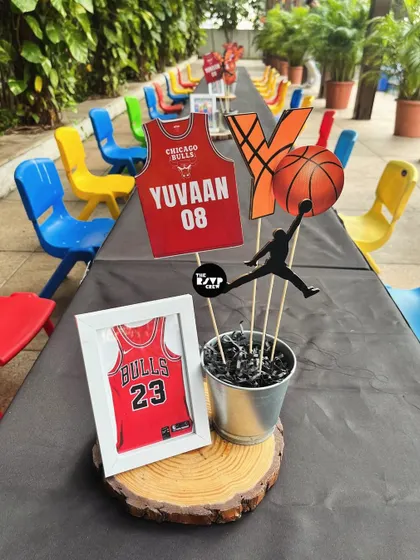 A slam-dunk centerpiece for a basketball-themed party, featuring a Michael Jordan silhouette and a framed Bulls jersey.