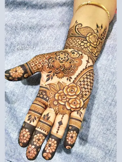 A classic Indian design that blends bold floral motifs with contemporary patterns. The dark fingertips provide a traditional contrast to the intricate work on the palms and wrists.