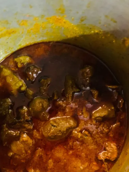 Two of my favourite dishes cooking. On the left, smoked pork with Aneshi (fermented taro leaves) and bamboo shoot juice. On the right, my spicy beef liver pickle with gallbladder, simmering in mustard oil.