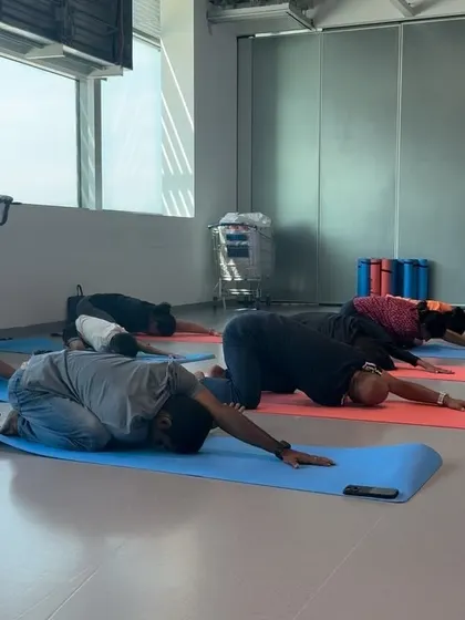Participants in Child's Pose (Balasana). This resting posture is offered throughout the class as a way to reconnect with the breath and release effort.