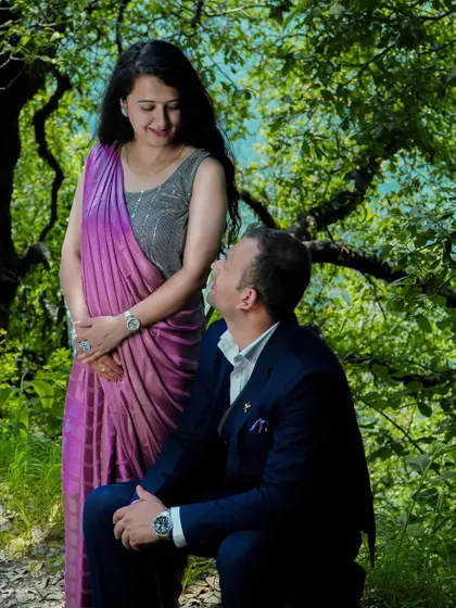 A romantic pose during a pre-wedding session in a forest. The natural green surroundings create a beautiful and serene atmosphere for couple portraits.
