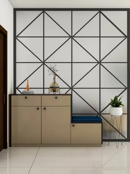 This foyer features a modern shoe cabinet with a seating nook, set against a geometric patterned partition. The design is both functional and serves as a beautiful decorative element.