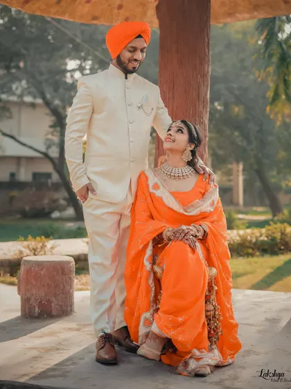 A beautifully composed portrait of the couple in a park. The composition and their relaxed poses give this photo a timeless, classic feel.