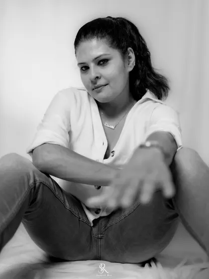 A bold, direct-to-camera pose in black and white. This monochrome shot highlights the attitude and confidence that a simple outfit can command.