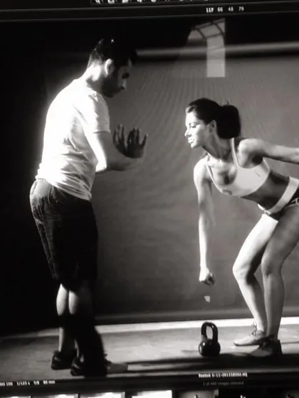 Behind the scenes, coaching an athlete on proper kettlebell swing form. Technique is everything.