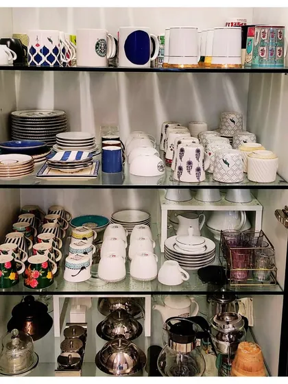 A well-organized crockery cabinet makes hosting so much easier. Here, I have grouped items by type and used risers to make everything visible and prevent chipping.