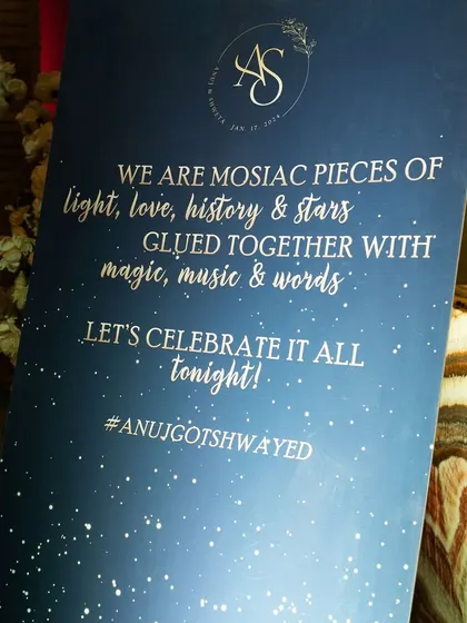 A beautifully worded welcome sign for a starry night themed sangeet. The quote "We are mosaic pieces of light, love, history & stars" perfectly captures the romantic and celestial theme.