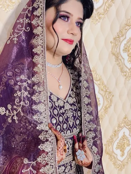 A beautiful reception look with a deep purple gown. The makeup is dramatic with purple smokey eyes and a red lip, paired with diamond jewellery for a modern touch.