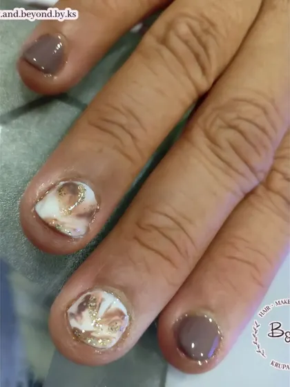 A macro shot of the marble nail art on these short nails. The blooming gel technique creates a soft, blended effect that looks incredibly sophisticated.