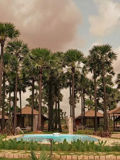 A central pool serves as the heart of this coastal resort, surrounded by villas that offer privacy and stunning views. The layout is designed to foster a sense of community while being immersed in a tropical landscape.