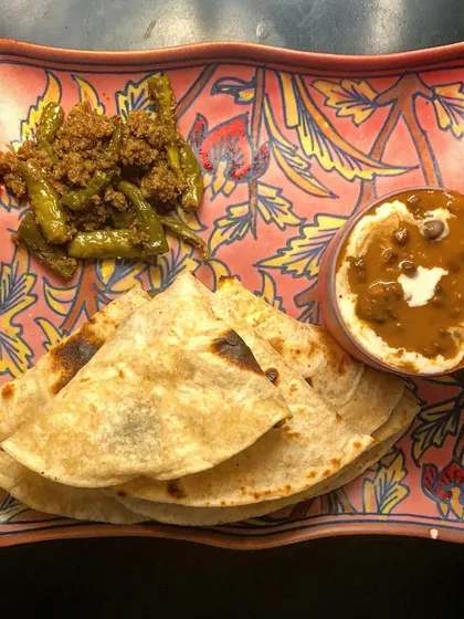 My Hari Mirchi ka Achaar, or green chili pickle, served with dal makhani and roti. This pickle packs a spicy punch and is full of Vitamin C and antioxidants.