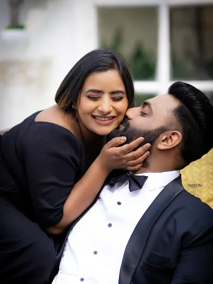 A sweet and playful moment. Her makeup is fresh and natural, with a beautiful smile being the main focus.