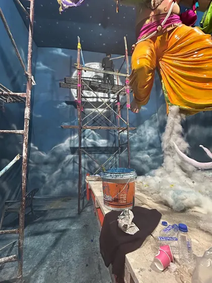 The reality of creating large-scale art. The pandal is our workshop, filled with paint, tools, and scaffolding. Every piece is created live on-site just before the festival begins.