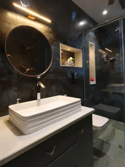 This charming washroom for a daughter's room at Harmony House features rustic dark wall tiles contrasted with light grey patterned floors.