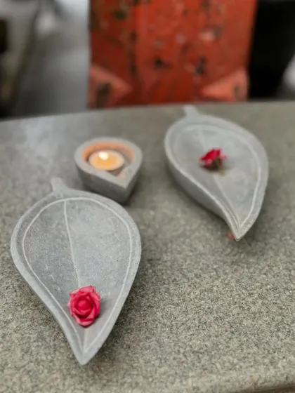 Small, leaf-shaped stone trays, perfect for holding a single flower or a small diya, adding a delicate touch to your decor.