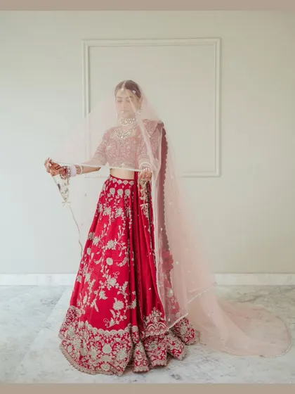 An ethereal portrait of the bride under her veil. The soft, sheer fabric creates a dreamy and romantic mood, adding a layer of mystery and elegance.