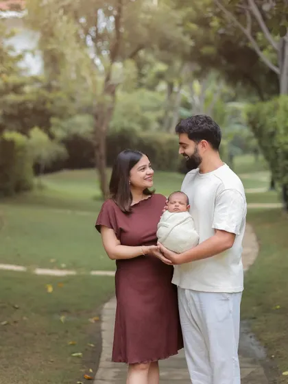 A full-family shot in a beautiful green park. Outdoor sessions are great for a relaxed and natural feel, allowing us to capture your family's connection in a serene setting.