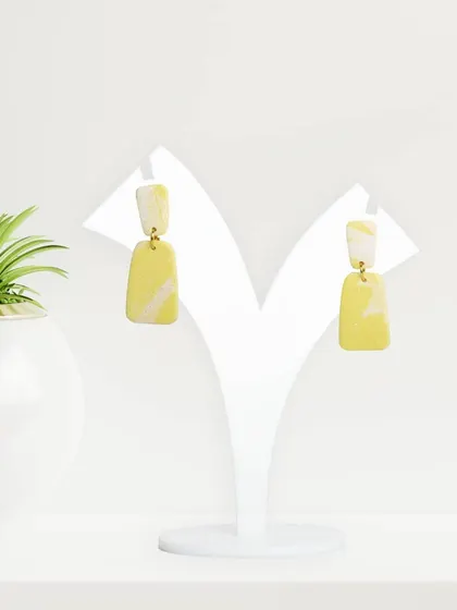 A pair of two-toned yellow earrings, presented in a clean, bright setting. We ensure consistent lighting and setup when shooting a full collection for a cohesive look.
