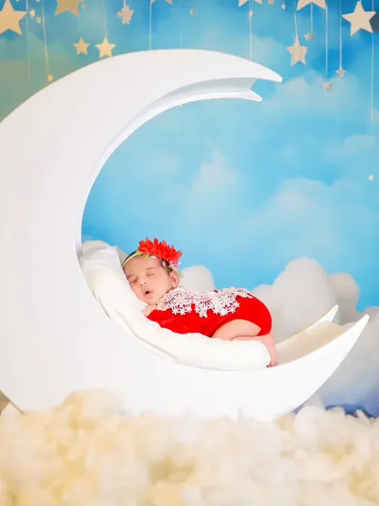 Another variation of our moon prop theme, this time with a newborn girl in a lovely red lace outfit.