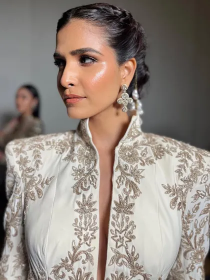 The final look, ready for the runway. The highlight on the cheekbones and the intricate hair detail come together to create a truly memorable bridal statement.