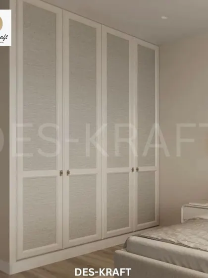 We designed this floor-to-ceiling wardrobe with textured panels to blend seamlessly into the wall, providing ample storage without visual clutter.