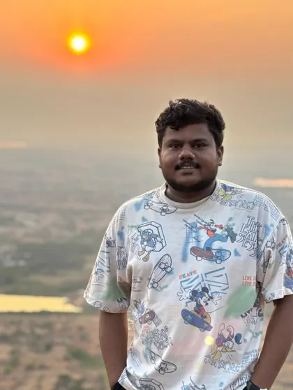 A happy trekker with the beautiful sunrise behind him. The golden hour light is perfect for photos.