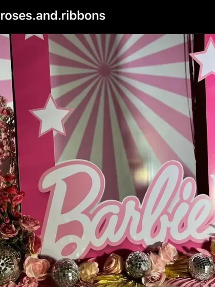 A close-up of the Barbie photo booth, showing the shimmering disco balls and floral details that add a touch of glam.