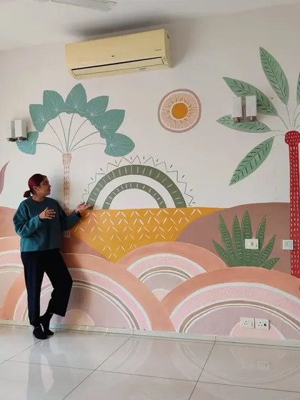 A candid shot of the client and me discussing the finished Boho mural. These conversations are a vital part of ensuring the artwork perfectly fits their vision.