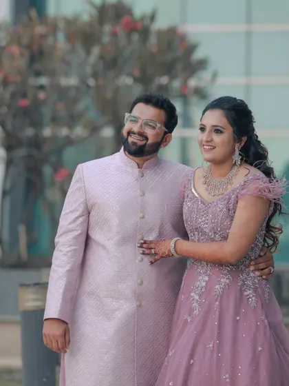 A beautiful formal portrait of an engaged couple. Their happy expressions and coordinated pastel outfits make for a perfect, classic engagement photo to cherish.