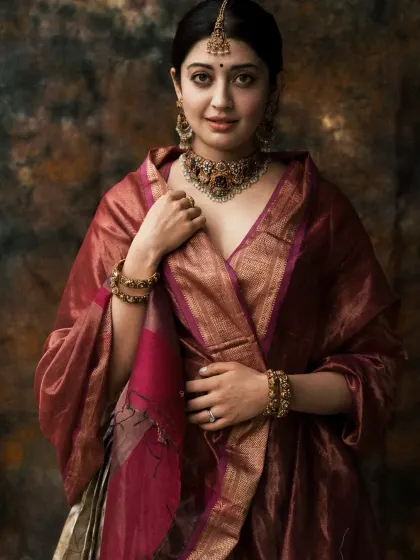 A close-up that captures the regal expression and the intricate details of the jewelry and attire.