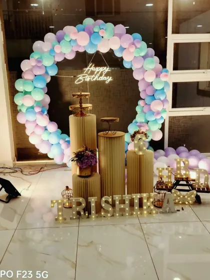 A sweet celebration for Trishika's 6th birthday. This setup features a pastel balloon ring, modern gold pedestals, and a light-up name sign for a chic and dreamy party.
