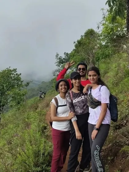 Four colleagues posing on the trail, capturing a memory from their Netravati Peak adventure.