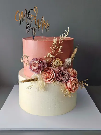 Anybody getting married? This two-tier chocolate cake with almond praline is perfect for a happily ever after, with a rustic floral arrangement in coral tones.