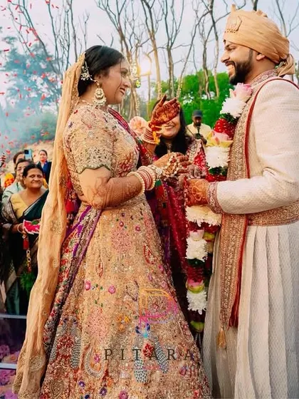 The Varmala moment, where two souls become one under a shower of petals. The decor is the backdrop, but their love story is the main event.