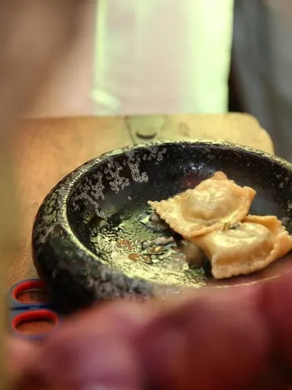 Freshly cooked ravioli served in a traditional stone bowl. Guests at our live stations can enjoy their pasta just moments after it's been cooked, ensuring the best possible texture and flavor.