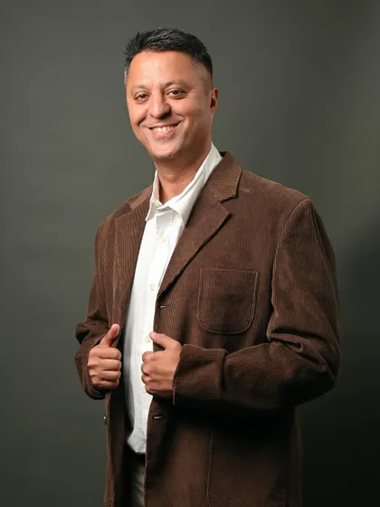 A studio portrait with a casual corduroy jacket. This look is perfect for a professional who wants to appear approachable and stylish, suitable for creative industries.