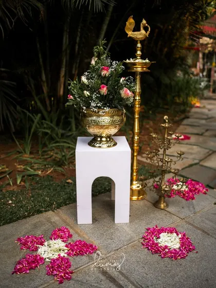 A beautiful floral arrangement with a traditional brass lamp, creating a serene and welcoming atmosphere.